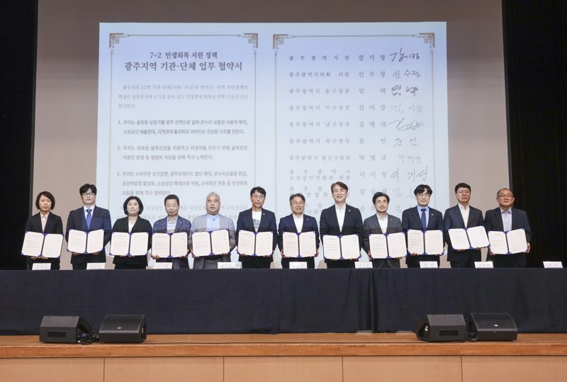 광주시는 23일 김대중컨벤션센터에서 '7+2 민생회복 지원 정책보고회'를 열어 총 6224억원 규모의 '7+2 소상공인 지원 패키지'를 시행한다고 밝혔다. 사진은 광주시와 자치구, 유관기관 등 12개 기관·단체가 '7+2 소상공인 지원 패키지'의 성공 추진을 위한 '골목형 상점가 광주전역 확대 업무협약(MOU)'을 체결하고 있는 모습. 광주광역시 제공