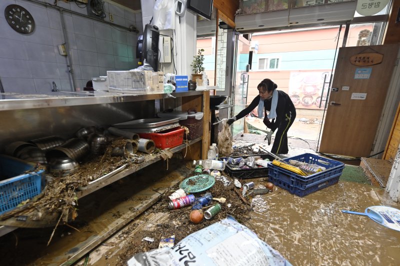 [함평=뉴시스] 박기웅 기자 = 4일 오전 전남 함평군 함평읍 한 음식점에서 식당 관계자가 침수 복구 작업을 벌이고 있다. 함평에는 전날 많은 비가 내리면서 주택 50가구와 상가 46곳이 침수된 것으로 잠정 집계됐다. 2025.08.04. pboxer@newsis.com