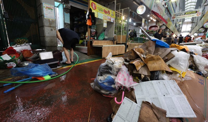 [인천=뉴시스] 전진환 기자 = 간밤에 내린 폭우로 인천 서구 석남동 인천강남시장 저지대가 침수된 가운데 13일 물이 빠진 후 상인들이 복구작업을 하고 있다. 2025.08.13. amin2@newsis.com