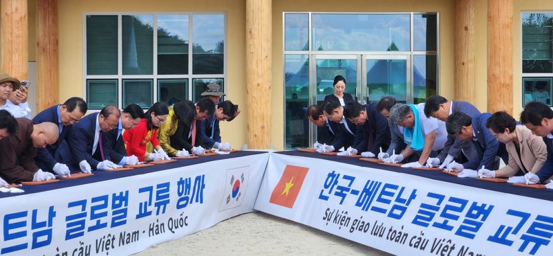 24일 봉화군 봉성면 창평리에서 '한국-베트남 글로벌 문화교류 행사' 중 다문화 커뮤니티센터 상량식에 앞서 참석자들이 기왓장에 각종 메시지를 적고 있다. 김장욱 기자