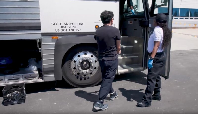 미국 이민세관단속국에 의해 체포된 한국인 직원이 손발이 묶인채로 소송차에 올라 타고 있다. 뉴스1