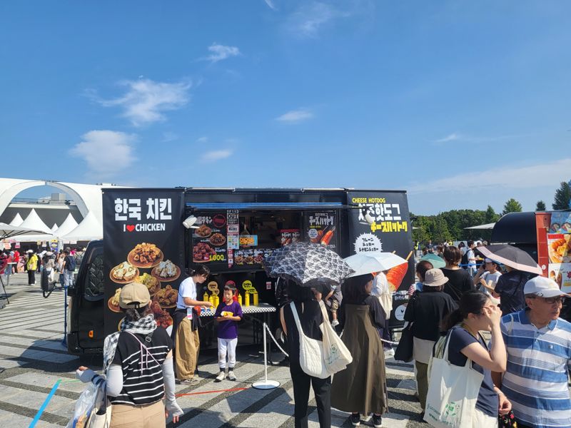 27일 일본 도쿄 세타가야구 고마자와 올림픽공원에서 열린 한일 문화교류 행사 '한일축제한마당'에서 한국 음식을 판매하는 푸드트럭 앞에 관객들이 줄을 서 있다.사진=서혜진 도쿄특파원