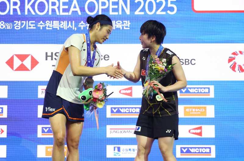 안세영과 일본 야마구치 아카네가 28일 경기 수원실내체육관에서 열린 2025 세계배드민턴연맹(BWF) 월드 투어 슈퍼 500 코리아오픈 여자 단식 결승전 시상식에서 인사를 나누고 있다.뉴시스