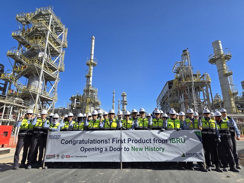 지난 25일(현지시간) 이라크 바스라 정유공장 고도화설비 현장에서 현대건설 임직원들이 가솔린 생산을 축하하는 플래카드를 들고 기념촬영을 하고 있다. 현대건설 제공