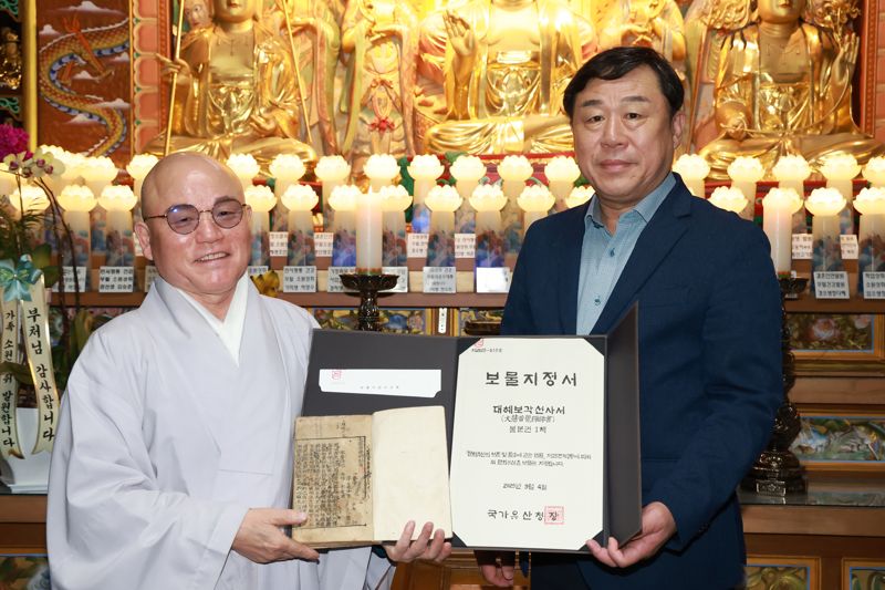 김종훈 울산동구청장과 등용사 주지 본명 스님이 대혜보각선사서와 국가유산청이 보내온 보물지정서를 들고 자축하고 있다. 울산 동구 제공