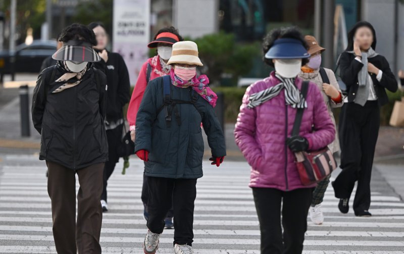 [광주=뉴시스] 이현행 기자 = 지난 27일 오전 광주 서구 치평동 한 거리에서 시민들이 추위에 맞서 꽁꽁 싸맨 채 횡단보도를 건너고 있다. 이날 광주 일최저기온은 광주 무등산이 2.8도를 기록했다. 2025.10.27. lhh@newsis.com