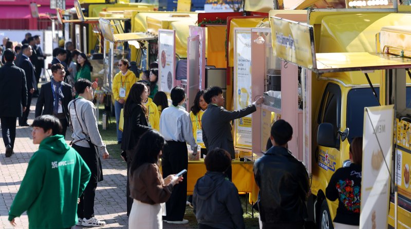 [경주=뉴시스] 추상철 기자 = 아시아태평양경제협력체(APEC) CEO 써밋이 열린 29일 경북 경주예술의전당 앞에 마련된 'KB 푸드트럭 파크' K-푸드 체험존에서 국내외 참가자들이 무료로 제공되는 음식을 시식하기 위해 길게 줄 서 있다. 2025.10.29. scchoo@newsis.com
