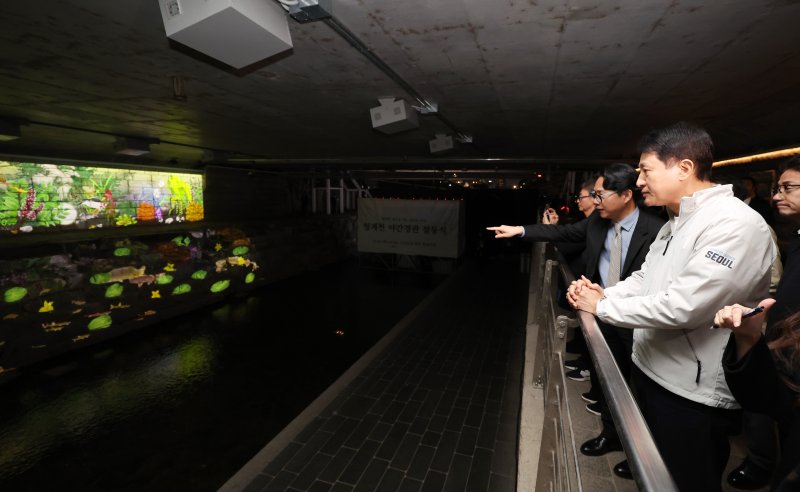 [서울=뉴시스] 이영환 기자 = 오세훈 서울시장이 30일 오후 서울 종로구 청계천 오간수교에서 열린 청계천 야간경관 점등식에서 미디어 아트를 관람하고 있다. 2025.10.30. 20hwan@newsis.com