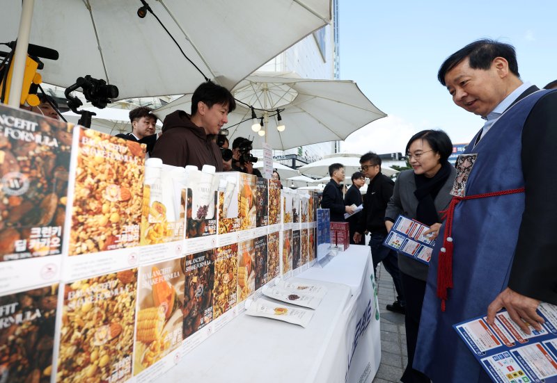 [서울=뉴시스] 홍효식 기자 = 2일 서울 중구 두타몰 광장에서 코리아 그랜드 페스티벌의 일환으로 열린 소상공인 우수제품 판매전 '모두의 동행' 행사에서 구윤철 기획재정부 장관과 한성숙 중소벤처기업부 장관이 식사대용 및 영양보충 쉐이크를 살펴보고 있다. 2025.11.02. yesphoto@newsis.com