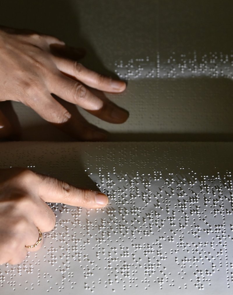 [수원=뉴시스] 김종택 기자 = '한글 점자의 날'을 하루 앞둔 3일 경기 수원시 영통구 장애인종합복지관 사랑샘도서관에서 관계자가 점자책을 읽고 있다. 2025.11.03. jtk@newsis.com