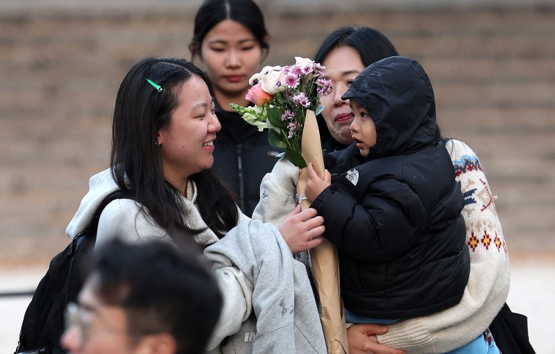 13일 오후 서울 중구 이화여자외국어고등학교에서 2026학년도 대학수학능력시험을 마친 수험생이 환한 얼굴로 시험장을 나서며 가족의 축하를 받고 있다. 2025.11.13/뉴스1 ⓒ News1 박지혜 기자