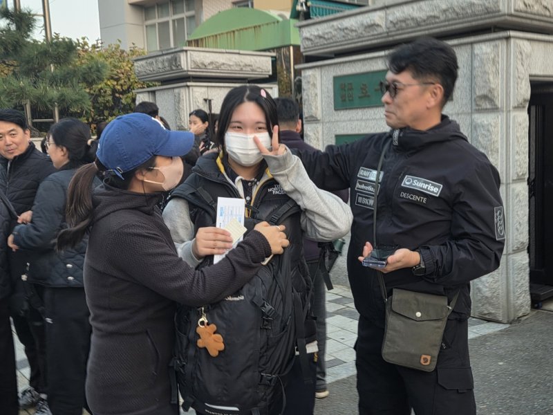 13일 대전 호수돈여고 시험장에서 수능을 마친 수험생이 가족과 함께 미소를 보이고 있다. ⓒ 뉴스1 김종서 기자