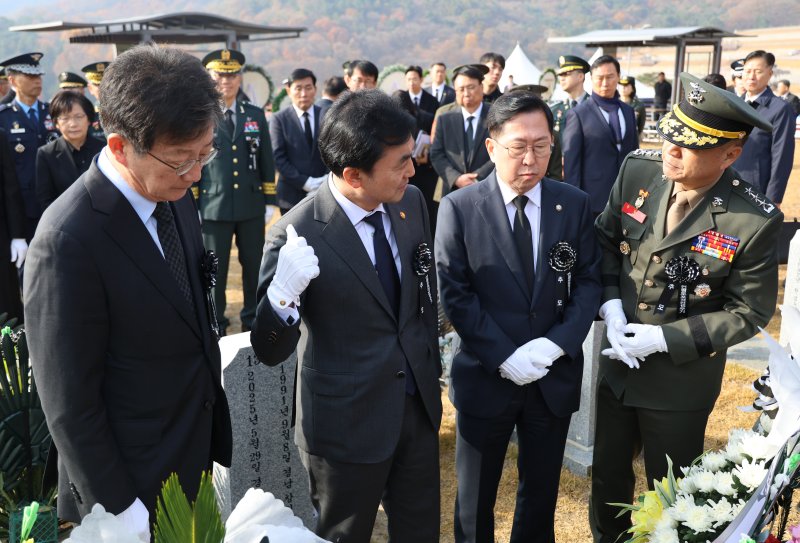 안규백 국방부 장관이 23일 대전 유성구 국립대전현충원에서 제15회 연평도 포격전 전투 영웅 추모 및 전승 기념식에 참석하기 전 채수근 상병의 묘비를 살피고 있다. 왼쪽부터 유승민 전 국민의힘 의원, 안규백 국방부 장관, 유용원 국민의힘 의원, 주일석 해병대 사령관. 연합뉴스