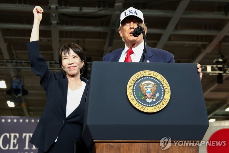 지난달 28일 미국 대통령 전용 헬기인 마린원을 타고 일본 요코스카 미 해군기지를 함께 방문한 다카이치 사나에 일본 총리(왼쪽)가 도널드 트럼프 대통령의 소개에 손을 들어보이며 인사하고 있다. 출처=연합뉴스