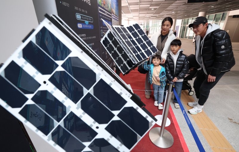 ‘경기기후위성’ 1호기 발사를 하루 앞둔 25일 경기 수원시 영통구 경기신용보증재단 도민쉼터에 마련된 경기기후위성 임시상황실에서 시민들이 '경기기후위성' 모형을 살펴보고 있다. ⓒ News1 김영운 기자