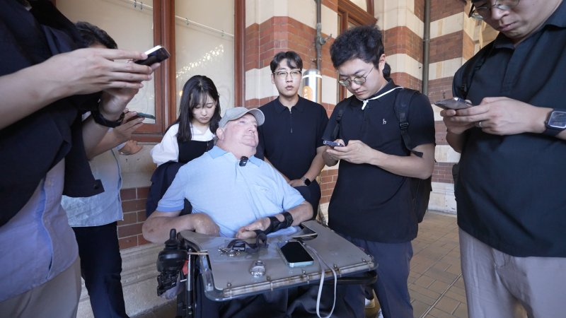 지난달 27일(현지 시간) 호주 시드니 센트럴역에서 그레그 킬린(63) 씨가 기자들과 인터뷰하는 모습. 척수 손상으로 장애를 입은 킬린 씨는 호주 NIF 2층 전동차 제작 과정에 피드백을 제공했다(현대로템 제공) 2025.12.1 ⓒ News1 박종홍 기자