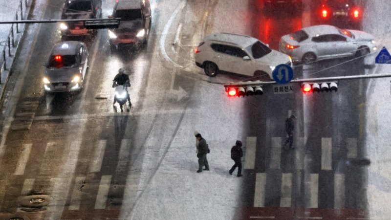 [서울=뉴시스] 최진석 기자 = 서울·인천·경기·강원 대설주의보 발효된 4일 서울 중구 도심에서 시민들이 횡단보도를 건너도 있다. 2025.12.04. myjs@newsis.com