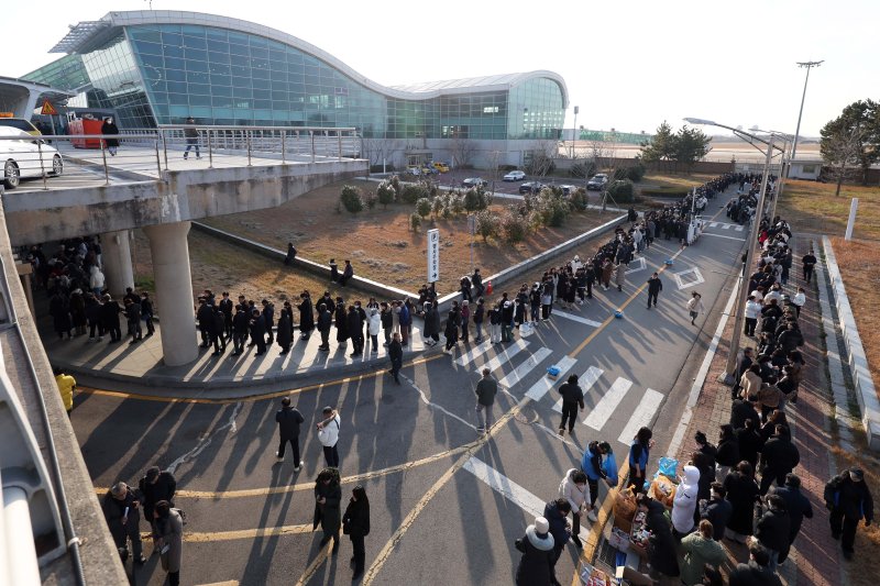 [무안=뉴시스] 김선웅 기자 = 1일 전남 무안군 무안국제공항에서 추모객들이 공항 내부에 마련된 제주항공 여객기 참사 희생자 합동분향소에서 추모를 하기 위해 줄을 서고 있다. 2025.01.01. mangusta@newsis.com