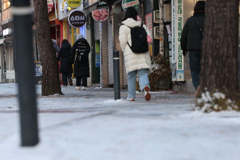 [서울=뉴시스] 권창회 기자 = 폭설 후 한파로 도로 곳곳이 얼어붙은 5일 오전 서울 중구 충무로역 인근에서 시민들이 빙판길을 조심히 걷고 있다. 2025.12.05. kch0523@newsis.com