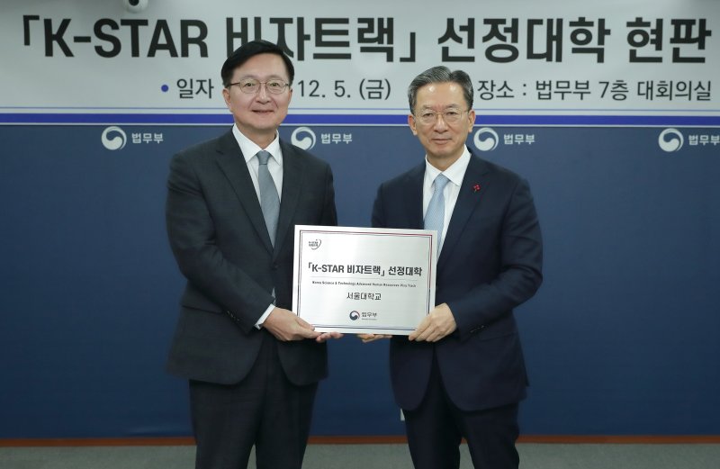 [서울=뉴시스] 정성호 법무부 장관이 5일 경기 과천시 정부과천청사에서 열린 'K-STAR 비자트랙 선정대학 현판 수여식'에 참석해 유홍림 서울대학교 총장에게 현판을 전달한 뒤 기념촬영 하고 있다. (사진=법무부 제공) 2025.12.05. photo@newsis.com *재판매 및 DB 금지