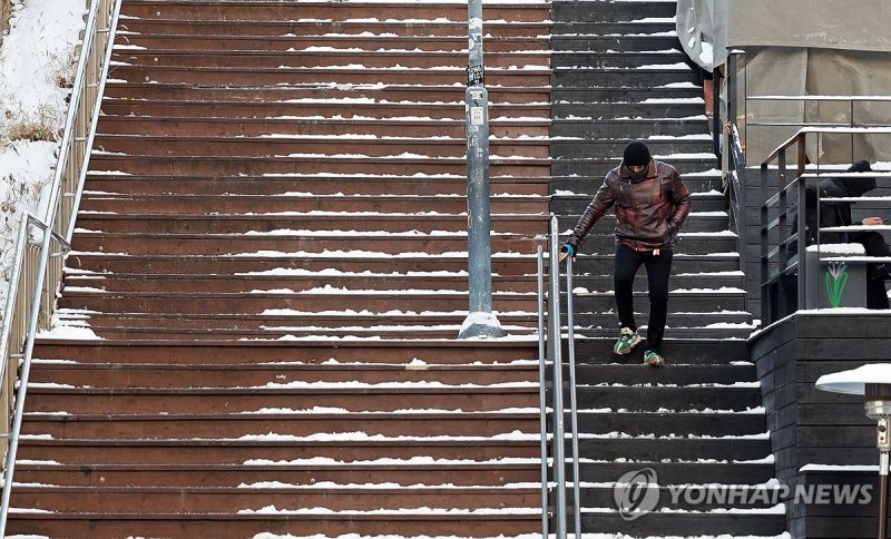 빙판길에 난간 붙잡고 이동 (출처=연합뉴스)