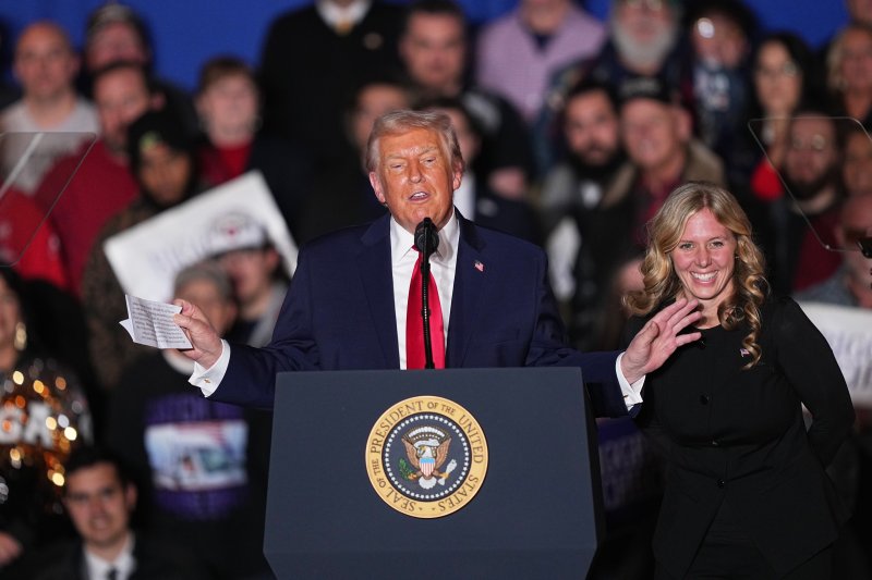 President Donald Trump reacts after Megan Hemhauser spoke at the Mount Airy Casino Resort in Mount Pocono, Pa., Tuesday, Dec. 9, 2025. (AP Photo/Matt Rourke)