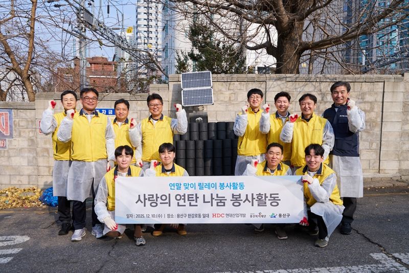 10일 서울 용산구에서 HDC현대산업개발 임직원들이 연탄 배달 봉사활동을 실시하고 기념 촬영을 하고 있다. HDC현대산업개발 제공