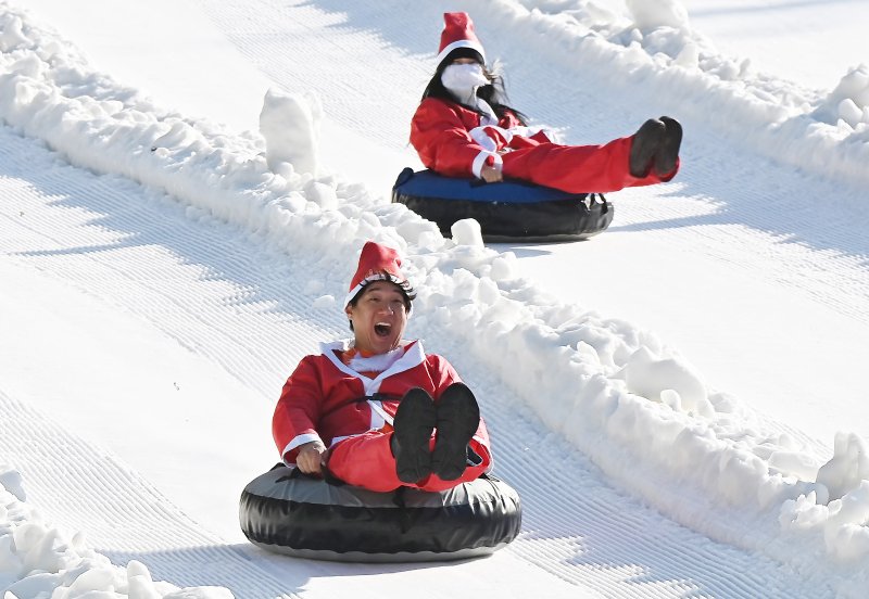 [용인=뉴시스] 김종택 기자 = 12일 경기 용인시 에버랜드 스노우버스터에서 산타복장을 한 시민들이 눈썰매를 타며 즐거운 시간을 보내고 있다. 2025.12.12. jtk@newsis.com