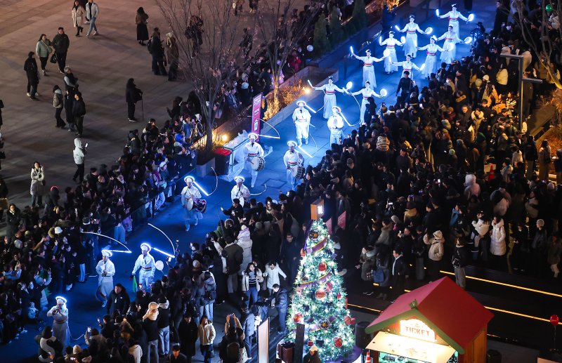 12일 오후 서울 세종대로 광화문광장에서 열린 ‘2025 서울윈터페스타’에서 광화문광장 마켓을 찾은 시민과 관광객들이 퍼레이드를 즐기고 있다. 2025.12.12/뉴스1 ⓒ News1 김진환 기자