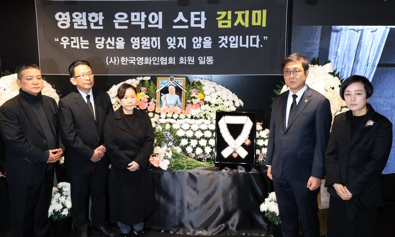 최휘영 문화체육관광부 장관(오른쪽 두 번째)이 14일 서울 중구 서울영화센터에 마련된 고 김지미 배우의 추모공간을 찾아 금관문화훈장을 전달한 뒤 유가족 및 영화업계 관계자들과 기념촬영을 하고 있다. 2025.12.14/뉴스1 ⓒ News1 이호윤 기자