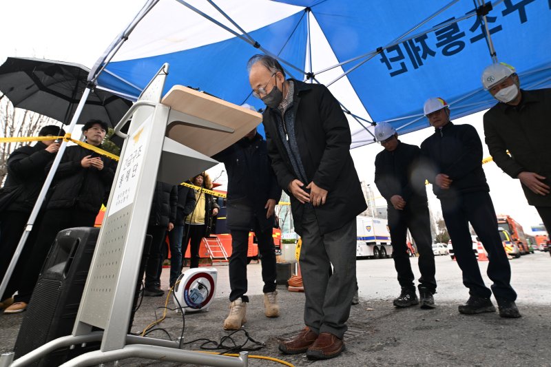 [광주=뉴시스] 이영주 기자 = 김찬석 구일종합건설 대표이사가 13일 오후 광주 서구 치평동 광주대표도서관 붕괴사고 현장 주변에서 브리핑 도중 고개를 숙이며 사과하고 있다. 2025.12.13. leeyj2578@newsis.com