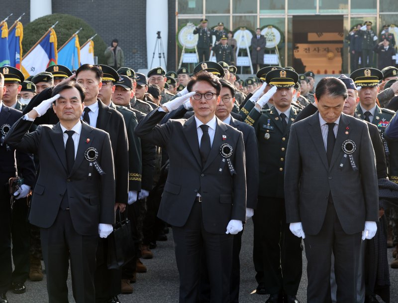 [서울=뉴시스] 배훈식 기자 = 김민석 국무총리가 15일 오전 서울 동작구 국립서울현충원에서 열린 2025년 6.25 전사자 합동봉안식에서 전사자 신위 봉송 행렬을 향해 경례하고 있다. 왼쪽부터 안규백 국방부 장관, 김 총리, 권오을 국가보훈부 장관. 2025.12.15. dahora83@newsis.com
