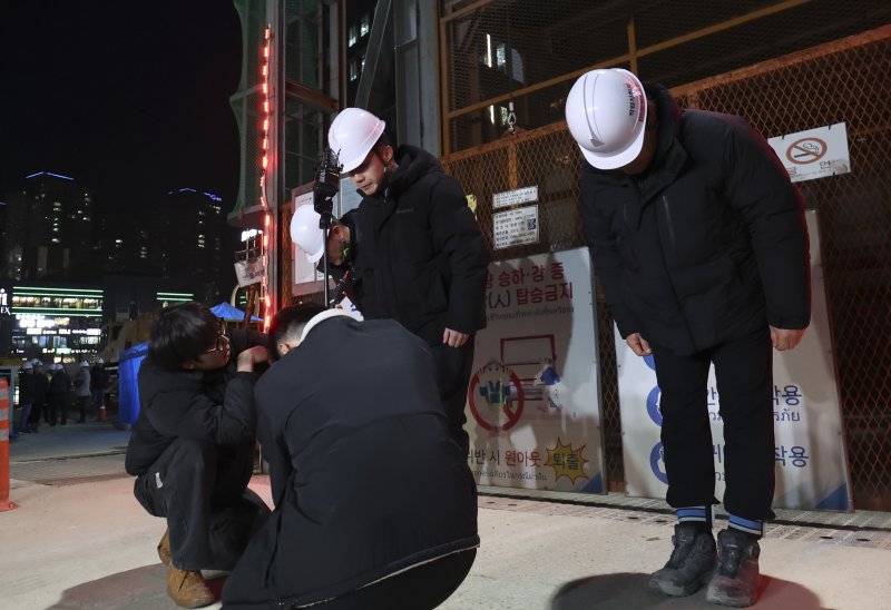 [서울=뉴시스] 김근수 기자 = 송치영(가운데) 포스코이앤씨 사장이 18일 저녁 서울 여의도역 신안산선 공사 사고현장에서 사과문을 발표하고 고개를 숙이고 있다.이날 여의도역 2번 출구 옆 신안산선 복선전철 4-2공구 지하 70m에 위치한 터널 공사 현장에서 작업자 7명 중 3명이 부상을 입었다. 50대 작업자 A씨는 터널 상단 약 16m 높이에서 낙하한 40m 길이의 철근망에 부상을 입고 심정지 상태로 이송됐으나 사망했다. 2025.12.18. ks@newsis.com