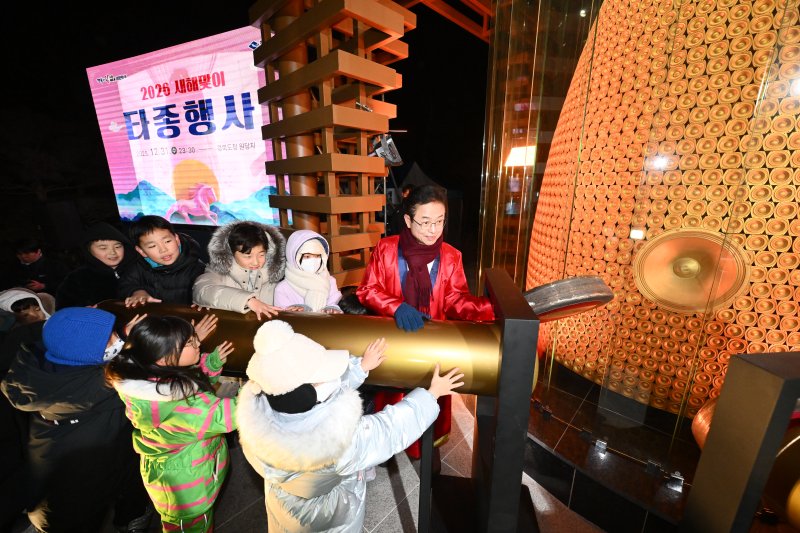 [안동=뉴시스] 새해 첫날 새벽 경북도청 원당지에서 이철우 경북지사가 어린이들과 타종을 하고 있다. (사진=경북도 제공) 2026.01.01. photo@newsis.com *재판매 및 DB 금지