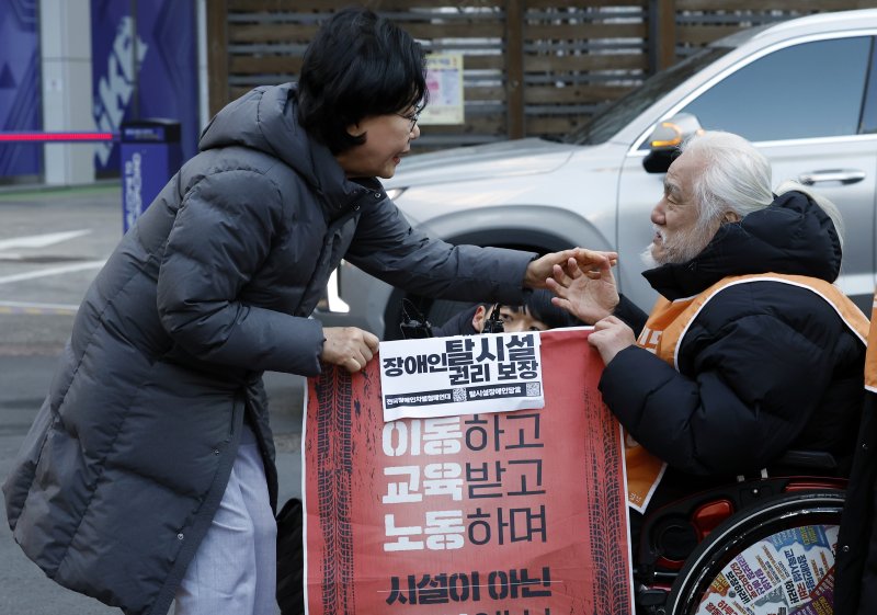 갑질·폭언 등 직장 내 괴롭힘 의혹이 제기된 이혜훈 초대 기획예산처 장관 후보자가 5일 오전 서울 중구 예금보험공사에 마련된 인사청문회 준비 사무실로 출근하며 박경석 전국장애인차별철폐연대 공동상임대표를 만나 장애인예산안에 대한 입장을 전달받고 있다. 2026.1.5/뉴스1 ⓒ News1 박정호 기자