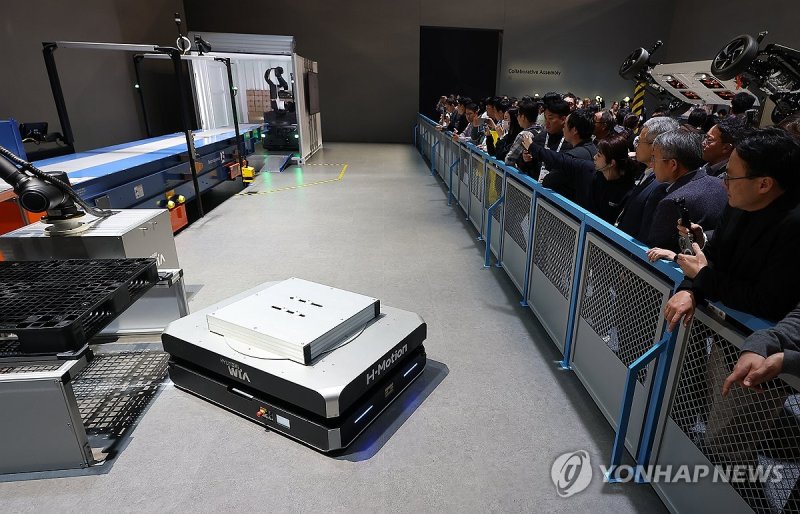 물류로봇 지켜보는 관람객들 (출처=연합뉴스)