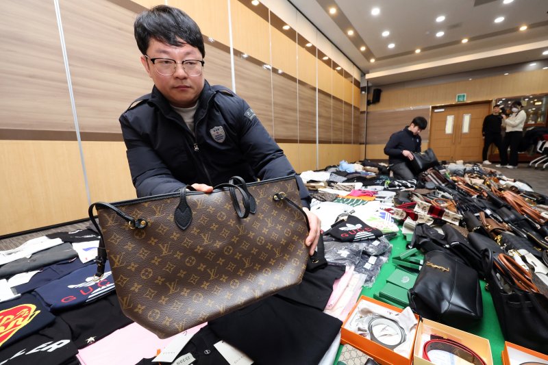 27일 오전 인천 중구 인천본부세관에서 열린 '1200억원대 위조 명품 판매 쇼핑몰 운영조직 적발' 브리핑에서 직원들이 압수품을 살펴보고 있다. 2026.1.27/뉴스1 ⓒ News1 황기선 기자