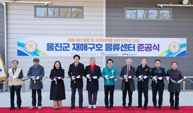 경북 울진군에서 열린 재해구호 물류센터 준공식에서 희망브리지와 울진군 관계자들이 기념 테이프를 자르고 있다. 희망브리지 제공