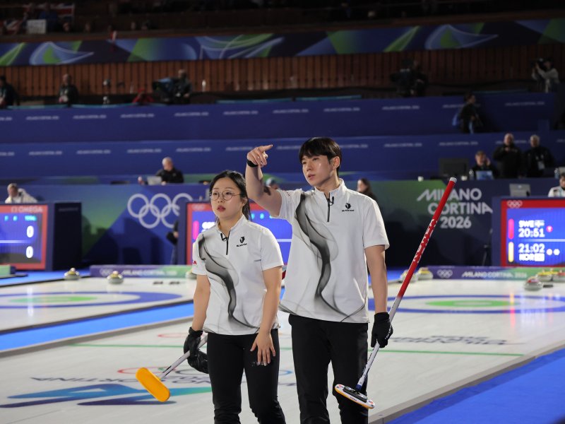 컬링 믹스더블 국가대표 김선영과 정영석이 4일(현지시간) 밀라노·코르티나 동계올림픽 컬링 믹스더블 라운드로빈 경기가 열린 이탈리아 코르티나담페초 컬링 올림픽 스타디움에서 일부 조명 정전으로 경기가 중단되자 작전을 상의하고 있다.연합뉴스