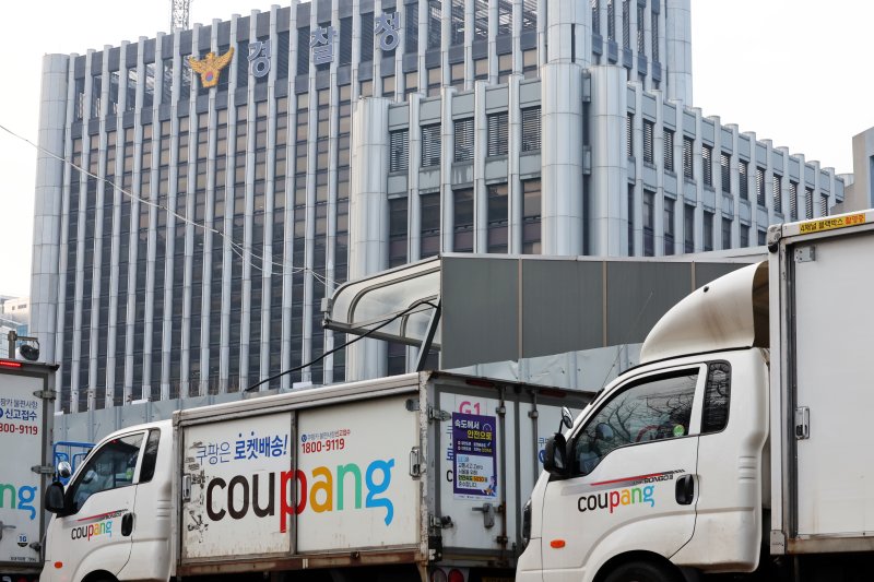 28일 서울 시내 한 쿠팡 물류센터 앞에 주차돼 있는 쿠팡카(쿠팡 배송트럭) 너머로 경찰청이 보이고 있다. 2025.12.28 / ⓒ 뉴스1 황기선 기자