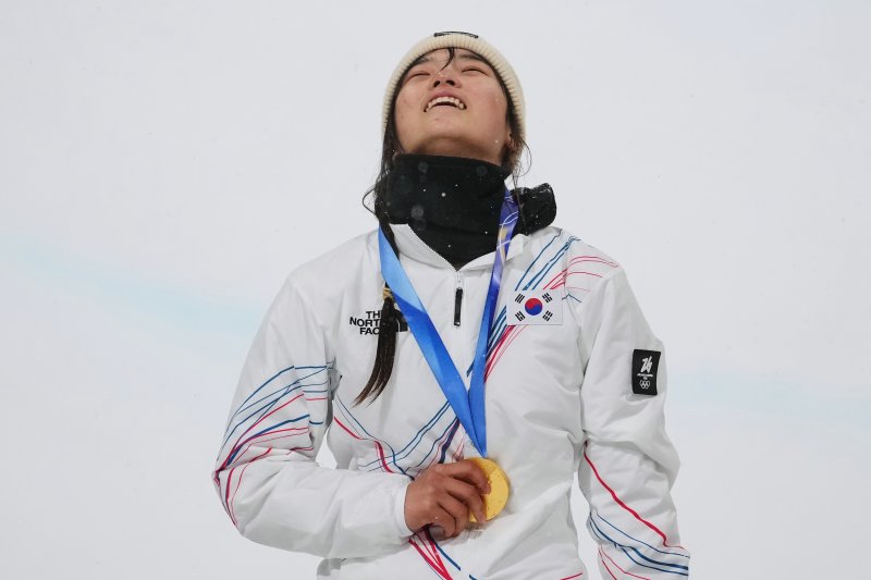 [리비뇨=AP/뉴시스] 최가온이 12일(현지 시간) 이탈리아 리비뇨 스노파크에서 열린 2026 밀라노·코르티나담페초 동계올림픽 스노보드 여자 하프파이프 정상에 올라 금메달을 목에 걸고 웃음 짓고 있다. 최가온은 1차 시기에서 크게 넘어져 충격을 안겼으나 3차 시기에서 90.25점을 획득해 강력한 우승 후보 클로이 김을 제치고 정상에 올랐다. 최연소 금메달 기록도 갈아치운 그는 시상식 도중 애국가가 흘러나오자, 끝내 눈물을 흘렸다. 2026.02.13.