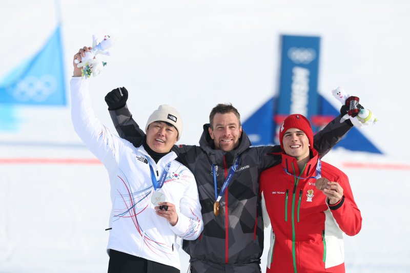 스노보드 남자 평행 대회전 은메달을 확보한 김상겸이 8일(현지시간) 이탈리아 리비뇨의 스노파크에서 열린 2026 밀라노·코르티나담페초 동계올림픽 스노보드 남자 평행 대회전 시상식에서 기뻐하고 있다. 왼쪽부터 김상겸, 베냐민 카를(오스트리아), 테르벨 잠피로프(불가리아). 2026.2.8 ⓒ 뉴스1 김진환 기자