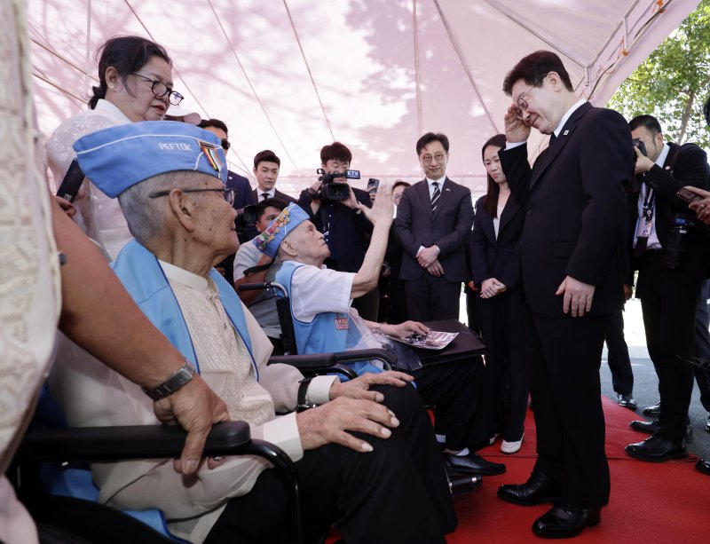 [마닐라=뉴시스] 최동준 기자 = 필리핀을 국빈 방문 중인 이재명 대통령이 4일(현지 시간) 마닐라 영웅묘지 한국전 참전기념비를 방문해 헌화를 마친 뒤 참전용사와 인사하고 있다. 이날 벤자민 산토스 한국전 참전용사, 로드리고 에레니오 한국전 참전용사, 프루덴시오 마누엘 한국전 참전용사가 참석했다. 2026.03.04. photocdj@newsis.com