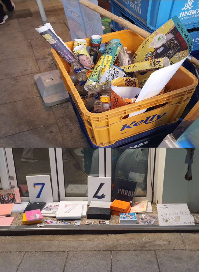 광화문 인근 상가 재활용 수거함에 공연 전단지와 페트병 등이 뒤섞여 버려져 있다. 공연 당일 일대에서는 쓰레기 투기가 곳곳에서 목격됐다.(아래) 광화문 인근 건물 앞에 BTS 앨범과 굿즈가 놓여 있다. 일부 구간에서는 무단 진열과 불법 상행위가 이어졌다. 사진=최승한 기자