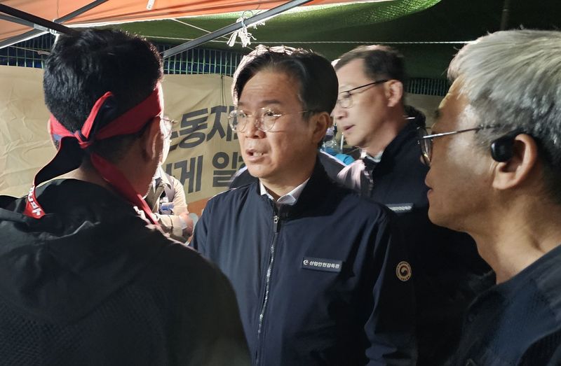 김영훈 고용노동부 장관(왼쪽 두번째)이 지난 20일 진주시 정촌면 CU 진주물류센터 앞 화물연대 집회 현장에서 대화하고 있다. 뉴스1