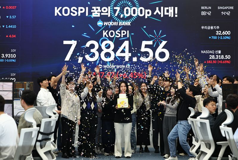 [서울=뉴시스] 김명년 기자 = 코스피가 7384.56으로 사상 최대치 마감한 6일 오후 서울 중구 우리은행 딜링룸에서 직원들이 축하 세리머니를 하고 있다. 2026.05.06. kmn@newsis.com