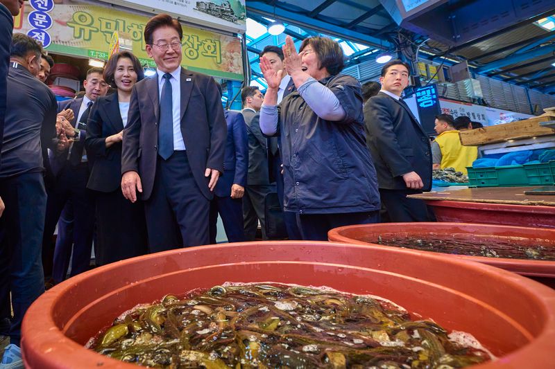 이재명 대통령과 김혜경 여사가 18일 광주 동구 남광주시장을 찾아 상인과 인사하고 있다. 청와대 제공