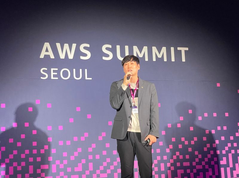 SM하이플러스 김성수 최고기술책임자(CTO)가 지난 20일 서울 강남구 코엑스에서 열린 ‘아마존웹서비스 서밋 서울 2026(AWS Summit Seoul 2026)’에서 연사로 무대에 올라 자사의 AWS 클라우드 전환 성과와 차세대 모빌리티 금융 플랫폼으로의 도약 비전에 대해 발표하고 있다. SM그룹 제공