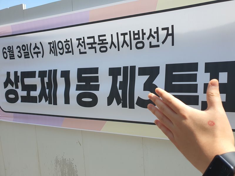 투표를 마친 최씨가 투표 인증샷을 촬영하고 있다. 사진=최승한 기자.
