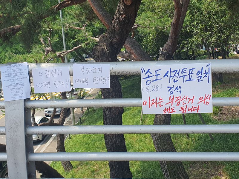 집회 현장 인근 난간에 부정선거 의혹을 제기하는 손팻말들이 걸려 있다. 사진=최승한 기자